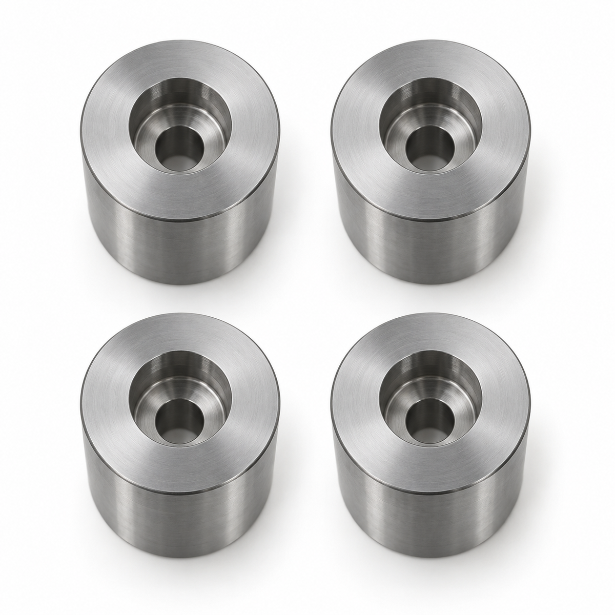 Top view of four S45C mold stop posts with counterbores